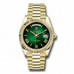 Gold watch with a green face on a white background