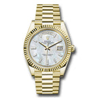 Gold wristwatch with a white face on a white background