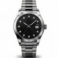 A stainless steel men's watch with a black dial and crystal hour markers, shown in a main front view and three smaller detail views highlighting the face, side profile, and skeletonized movement.