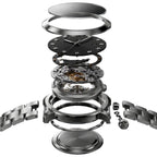 An exploded view of a stainless steel watch, showing the separate components such as the bracelet, case, dial, gears, and movement mechanism arranged vertically against a dark gray background.